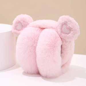 Detail of pink plush earmuffs with heart embroidery and soft faux fur texture