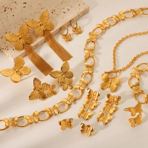Golden butterfly jewelry set including necklace earrings and ring with brushed metal finish