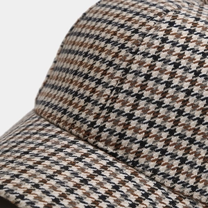 Close-up of houndstooth baseball cap showing detailed fabric texture and stitching