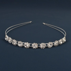 Detailed macro view of silver tiara headband with sparkling round crystals in a double row