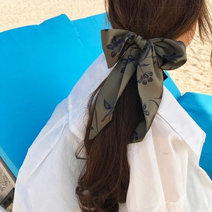 Floral print hair scarf ribbon in dark green and blue tied in a bow on a ponytail