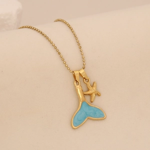 Golden bead chain necklace featuring a blue enamel fishtail and small starfish pendant