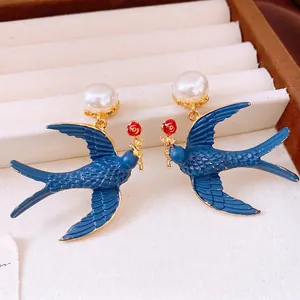 Baroque style pearl swallow earrings with blue enamel and red rose floral accents