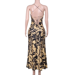 Detail of yellow floral satin dress featuring crisscross back straps and open back