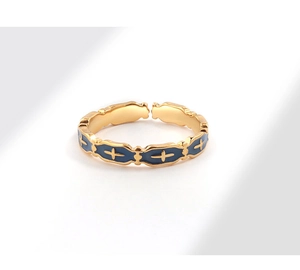 Detailed macro view of the gold open ring with blue enamel and cross pattern