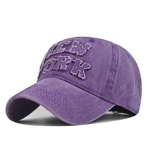 Close-up of vintage purple washed cotton baseball cap with New York patch embroidery