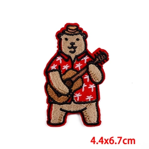 Embroidered patch featuring a cute brown bear playing ukulele in a red Hawaii shirt