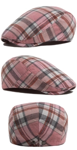 Detail of pink herringbone flat cap showing fabric texture and adjustable metal buckle