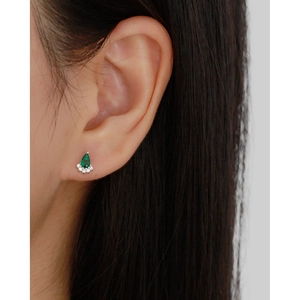 Close-up of S925 silver emerald drop earring with diamonds on ear