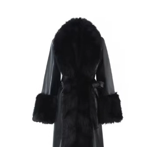 Women's black long slim coat with faux fur collar and waist belt on white background