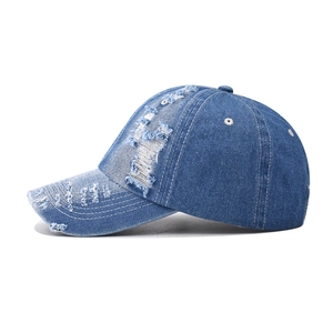 Vintage distressed blue denim baseball cap with stylish ripped holes and washed texture