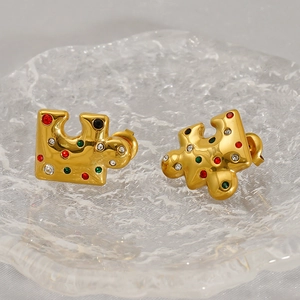Detailed view of puzzle-shaped gold-plated stud earrings with colorful zircon stones