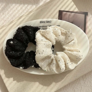 Tweed scrunchies set with sequins and faux pearls in black and off-white colors