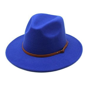 Close-up of royal blue fedora hat featuring a brown leather band and metal buckle detail
