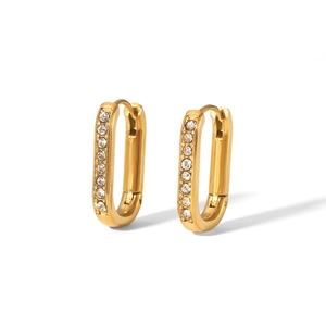 Close-up of gold oval hoop earrings with sparkling rhinestones on white background