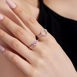 Close-up of S925 sterling silver rings with pink heart zircon and hollow heart design