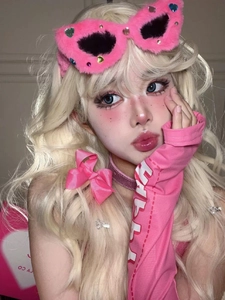 Close-up of pink plush headband and heart hairpins with stylish arm sleeves for cosplay