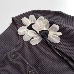 Deep grey-purple ribbed knit cardigan featuring oversized white 3D floral accents on collar