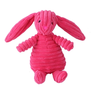 Detail of pink corduroy plush dog chew toy showing soft textured fabric and long rabbit ears