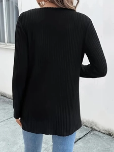 Detail of black knit cardigan featuring vertical ribbed texture and minimalist back view