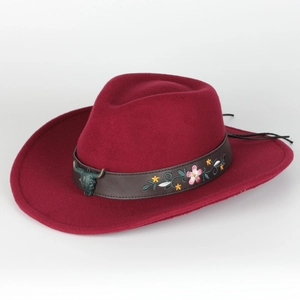 Detail of burgundy wool fedora featuring floral leather band and bronze bull head stud