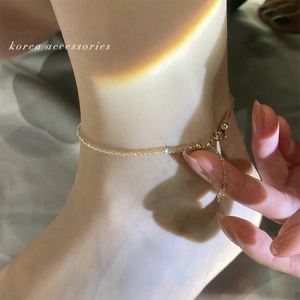 Close-up of a beaded crystal anklet on an ankle with rainbow light and lobster clasp