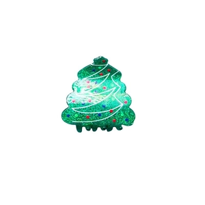 Sparkly green Christmas tree hair claw clip with colorful decorations for festive styling