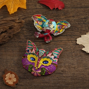 Detailed view of colorful rhinestone elephant brooch with enamel on dark wood background