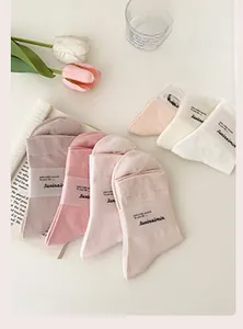 Flat lay of soft cotton socks set in pastel colors with aesthetic prop styling