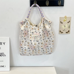 Detail of quilted canvas tote with cute puppy prints and colorful braided rope handles