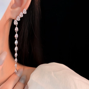 Detail of silver drop zircon tassel earrings showing long linear fringe and crystals