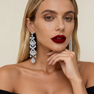 Close-up of model wearing silver tassel flower earrings with sparkling crystals for gala