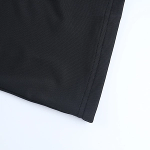 Detailed macro shot of the double-needle stitching on the black dress hemline