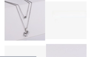 Detail of silver double-layered stainless steel necklace with butterfly pendant