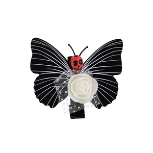 Gothic butterfly hair clip with white roses and red skull center on white background