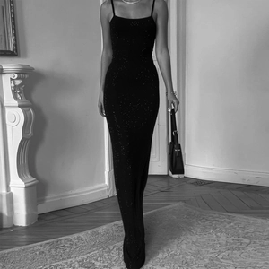 Macro detail of slim-fit backless black dress with sparkling rhinestones and straps