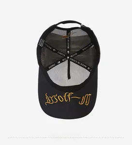 Detailed view of black trucker hat interior showing high-quality stitching and mesh texture