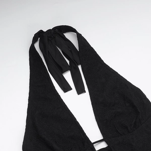 Close-up of black lace necktie detail and intricate floral patterns on a slim jumpsuit