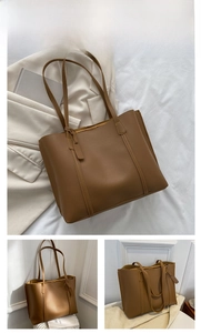 Detail shot of a brown soft PU leather tote bag with ample interior space and thin straps