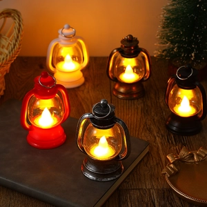 Vintage LED Christmas lanterns in various colors on a wooden table with warm light