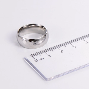 Polished silver stainless steel Mobius ring with rhombus faceted pattern and 8mm width