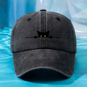 Detailed close-up of cat embroidery on washed cotton baseball cap in dark grey