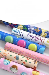 Detail of colorful birthday wrapping paper with cupcakes, stars and balloons patterns