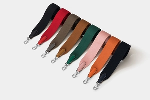Selection of eight colorful woven canvas shoulder straps with leather ends and metal hooks