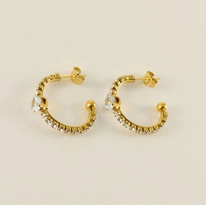 Detail of 18K gold C-shaped earrings with square zircon and micro-pave setting