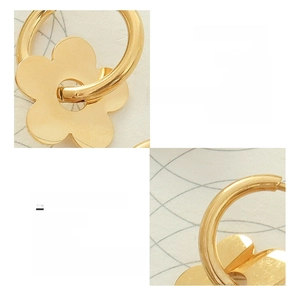 Macro detail of 18K gold plated titanium steel flower earring with polished finish