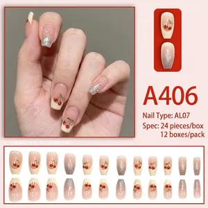French tip press-on nails with red cherry designs and silver glitter on light pink base