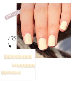 Close-up of matte creamy yellow press-on nails in short square shape and full set layout
