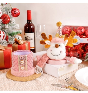 Festive pink reindeer ornament and sequined storage container in a Christmas table setting