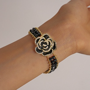 Close-up of black 3D rose bracelet with sparkling crystals and beaded layers